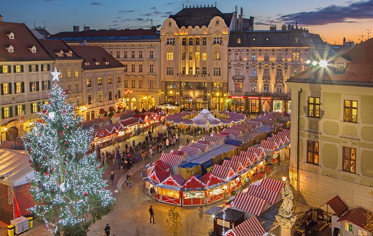 Red Christmas market stalls lit up with festive lights in Bratislava, Slovakia's main town square
