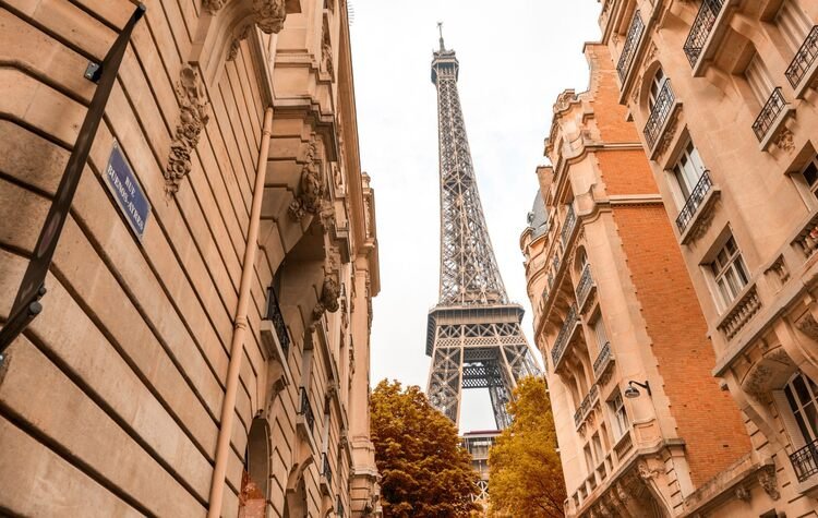 Eiffel Tower between Parisian buildings