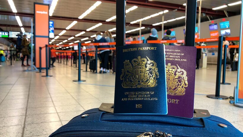 Passports on top of suitcase in check-in area