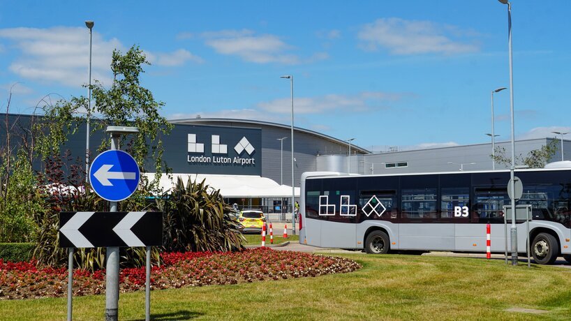 Terminal front of London Luton Airport with shuttle bus departing